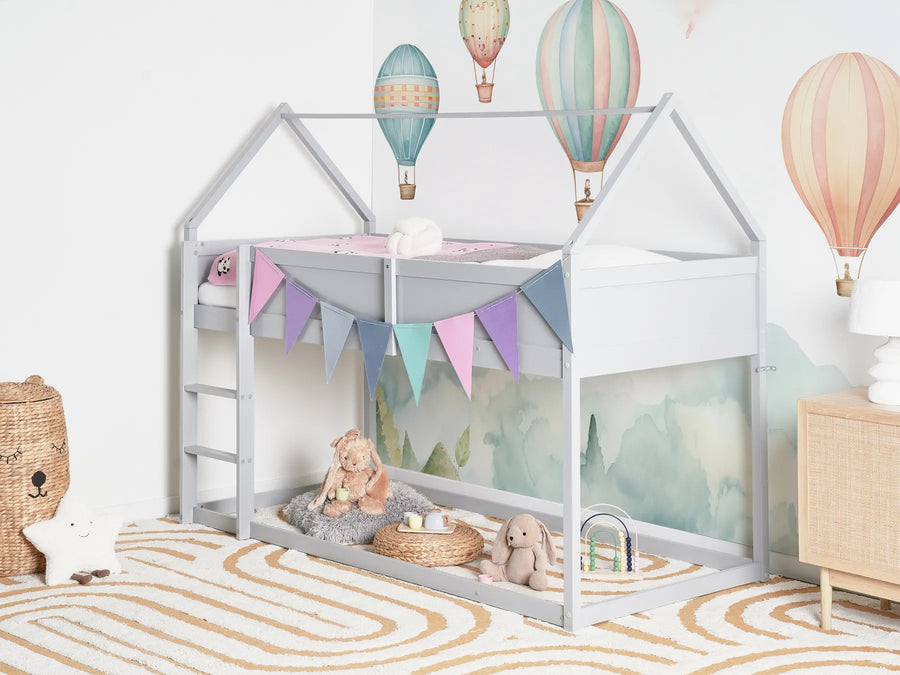 Children's room with a house-shaped bed, toys, and colorful hot air balloons on the wall.