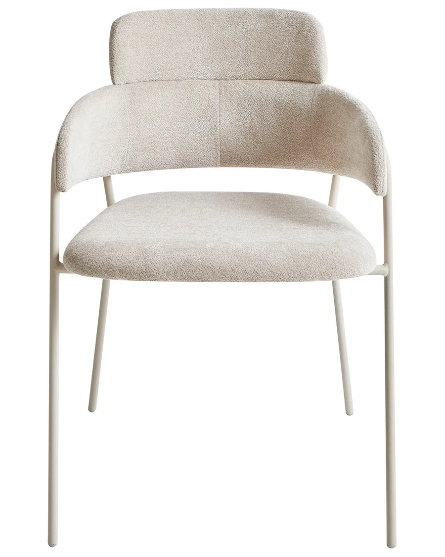 Bouclé dining chair with a curved silhouette, padded backrest, and soft neutral upholstery.