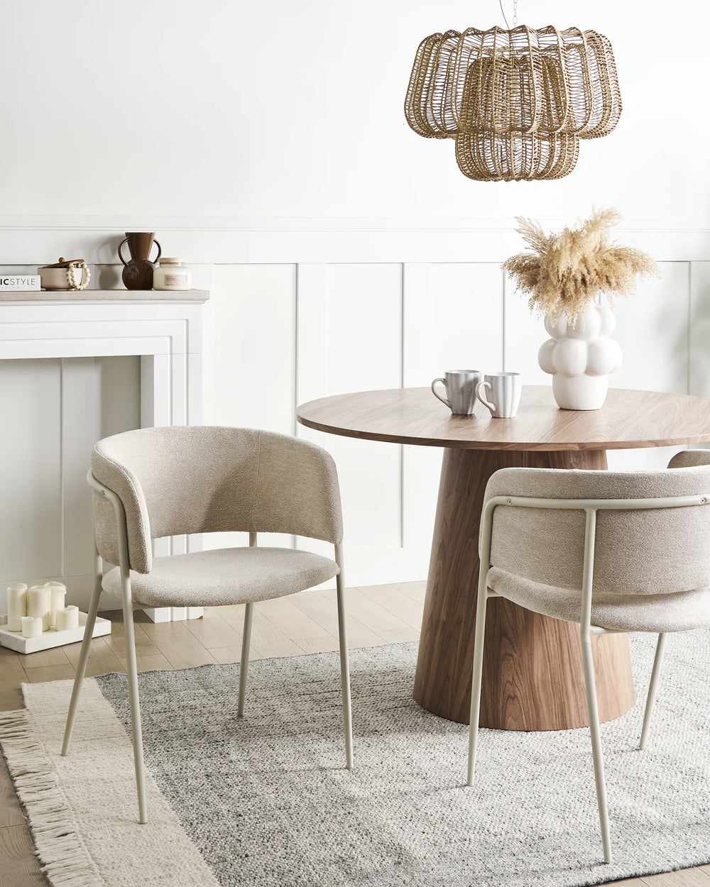 Elegant dining setting featuring beige bouclé chairs paired with warm wood accents and neutral décor, creating a cozy and sophisticated atmosphere.