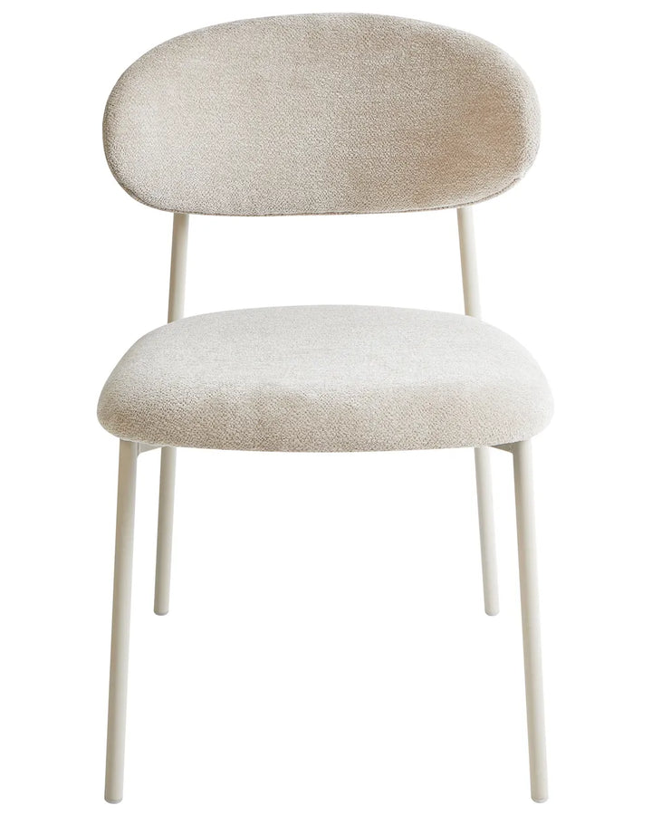 Cream bouclé dining chair with a rounded backrest, cushioned seat, and white metal legs.