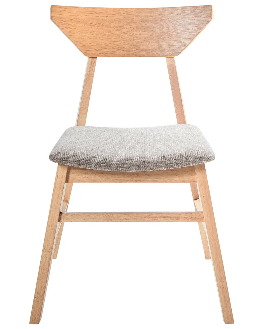 Scandinavian-inspired dining chair featuring a solid wood frame in a natural oak finish with a distinctive angular backrest design. The chair includes a gently curved, upholstered seat in a soft light-grey fabric, offering comfort and support for everyday dining. Its clean lines, tapered legs, and minimalist silhouette create a timeless look that complements modern, Nordic, and contemporary interiors.