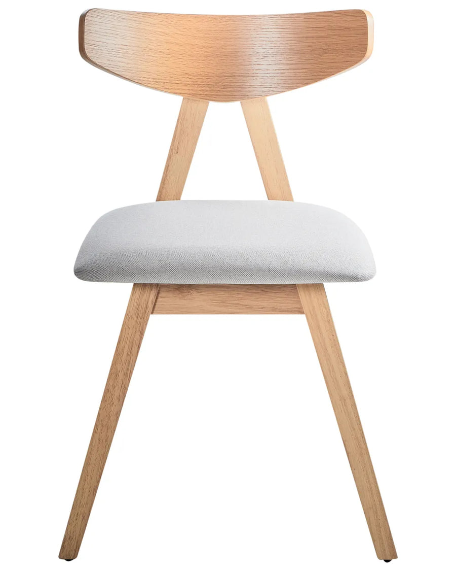 Scandinavian-inspired dining chair featuring a sculptural curved wood backrest, solid light oak-effect frame, and a generously padded light grey upholstered seat. The angled legs and minimalist silhouette create a clean, modern look while providing lasting comfort and stability for everyday dining.