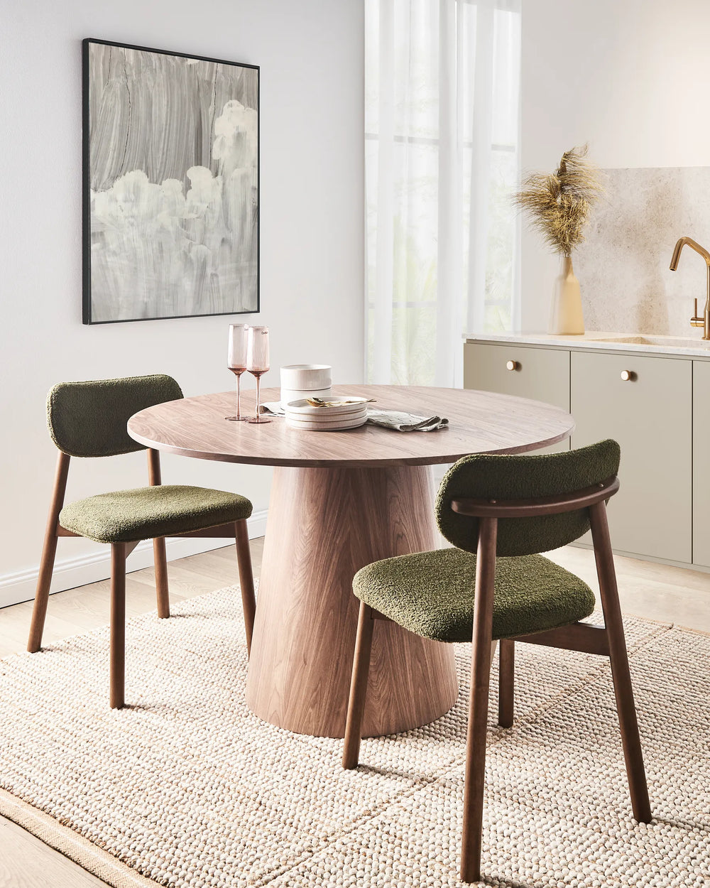 Elegant dining space showcasing textured bouclé chairs in a warm olive tone, paired with rich wood finishes for a refined, contemporary look.