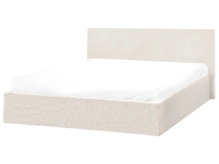 Beige upholstered bed frame with white mattress