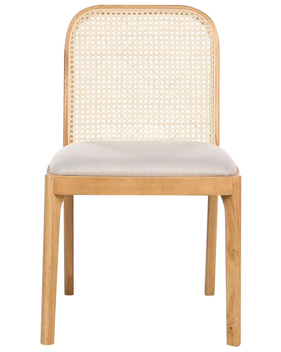 Dining chair with a natural wood frame, woven rattan backrest, and cushioned fabric seat for a timeless, airy look.