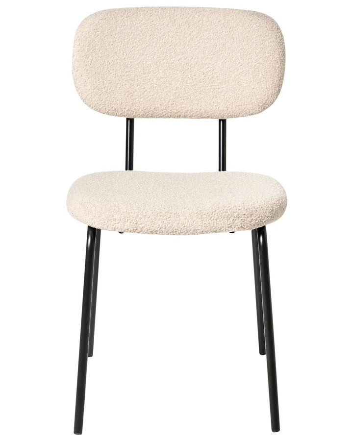 Beige bouclé dining chair without armrests, with a softly curved upholstered backrest and padded seat, on slim black metal legs.