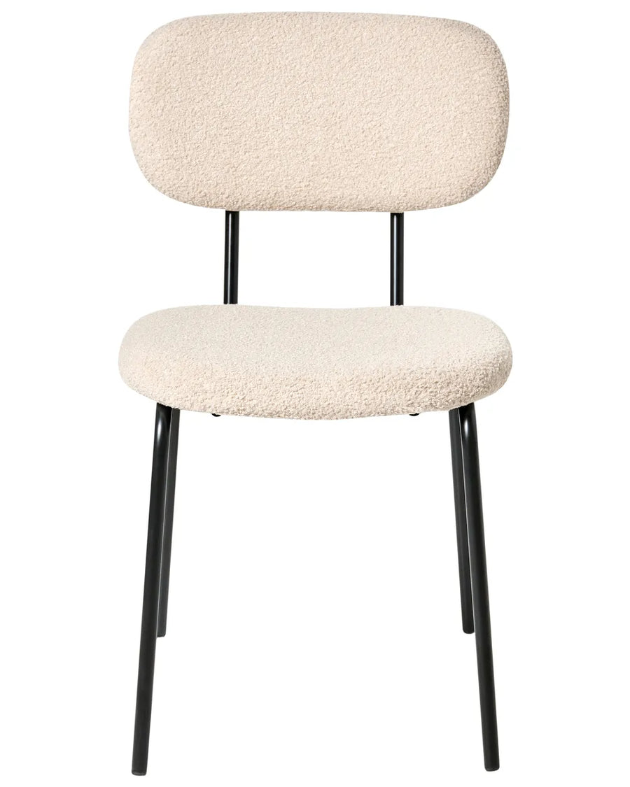 Beige bouclé dining chair without armrests, with a softly curved upholstered backrest and padded seat, on slim black metal legs.