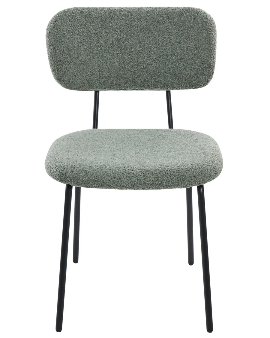 Light green bouclé dining chair without armrests, with a softly curved upholstered backrest and padded seat, on slim black metal legs.