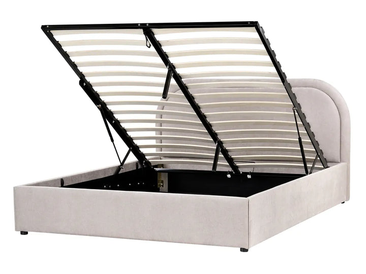 Beige upholstered bed frame with black metal headboard on a white background