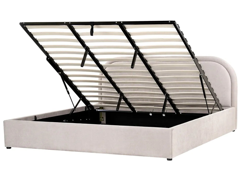 Beige upholstered bed with black metal frame on a white background