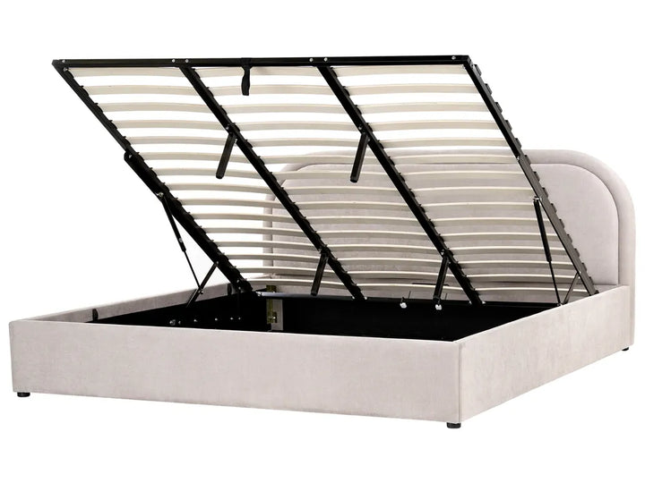 Beige upholstered bed with black metal frame on a white background