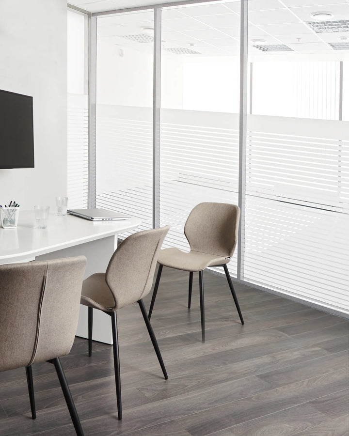 Modern office-style dining space featuring comfortable upholstered chairs with a sleek, contemporary design.