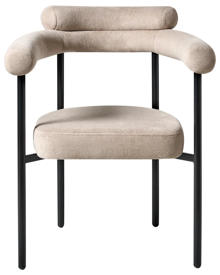 Beige fabric dining chair with a wide rounded backrest, padded seat with integrated armrests, and slim black iron legs.