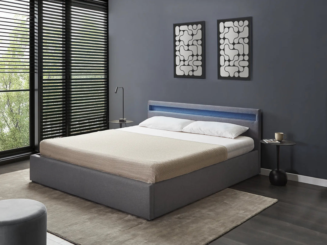 Modern bedroom with a gray bed, nightstands, and abstract wall art.