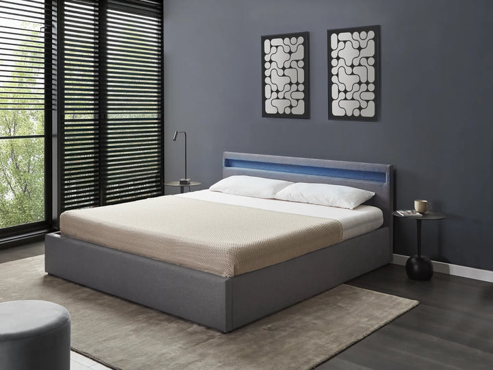 Modern bedroom with a gray bed, nightstands, and abstract wall art.