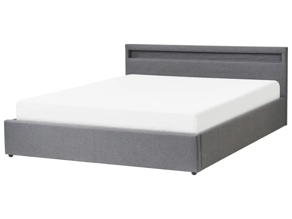Gray upholstered bed with white mattress on a white background