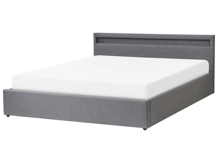 Gray upholstered bed with white mattress on a white background