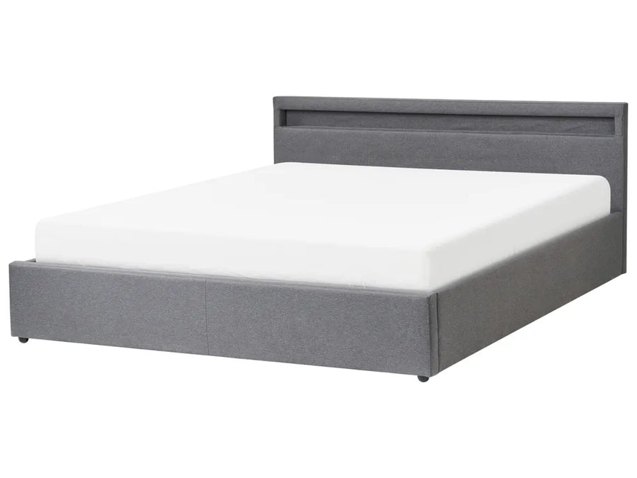 Gray upholstered bed with white mattress on a white background