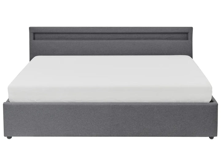 Gray upholstered bed with white mattress on a white background