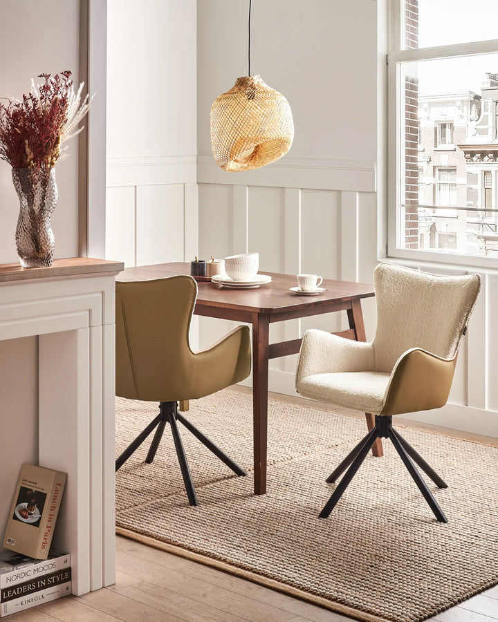Light beige bouclé swivel dining chairs with black metal bases around a dining table in a bright, modern dining space with minimalist décor.