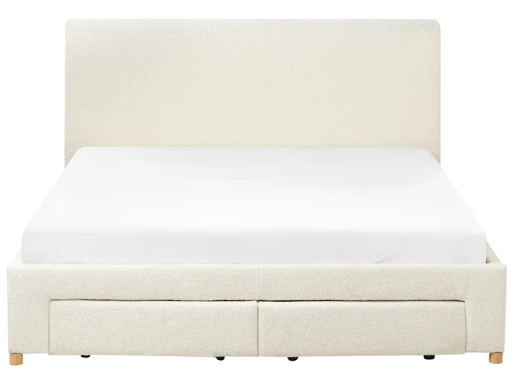 Beige upholstered bed with white mattress on a white background