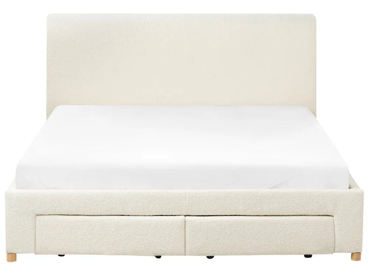 Beige upholstered bed with white mattress on a white background
