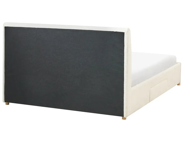 Bed frame with black upholstered headboard and white mattress on a white background