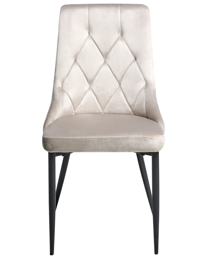 Light grey velvet dining chair with diamond-tufted stitching and sleek black metal legs.