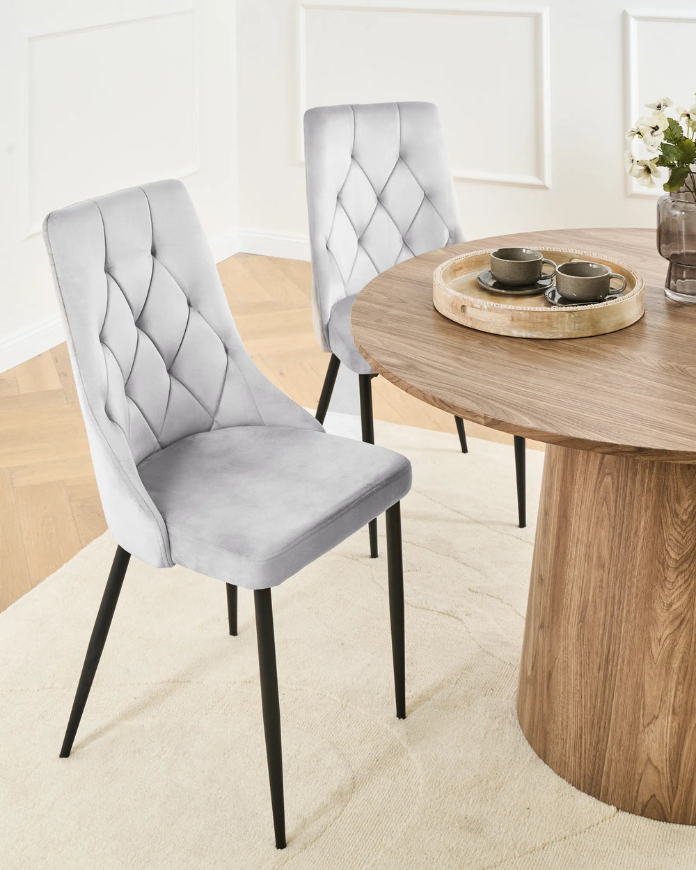 Contemporary dining setting featuring elegant grey velvet chairs that bring comfort and refined style to the space.