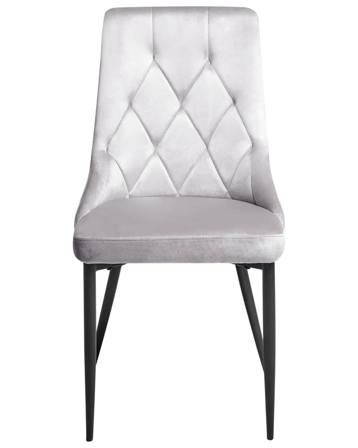 Light grey velvet dining chair with diamond-tufted detailing and slim black metal legs.