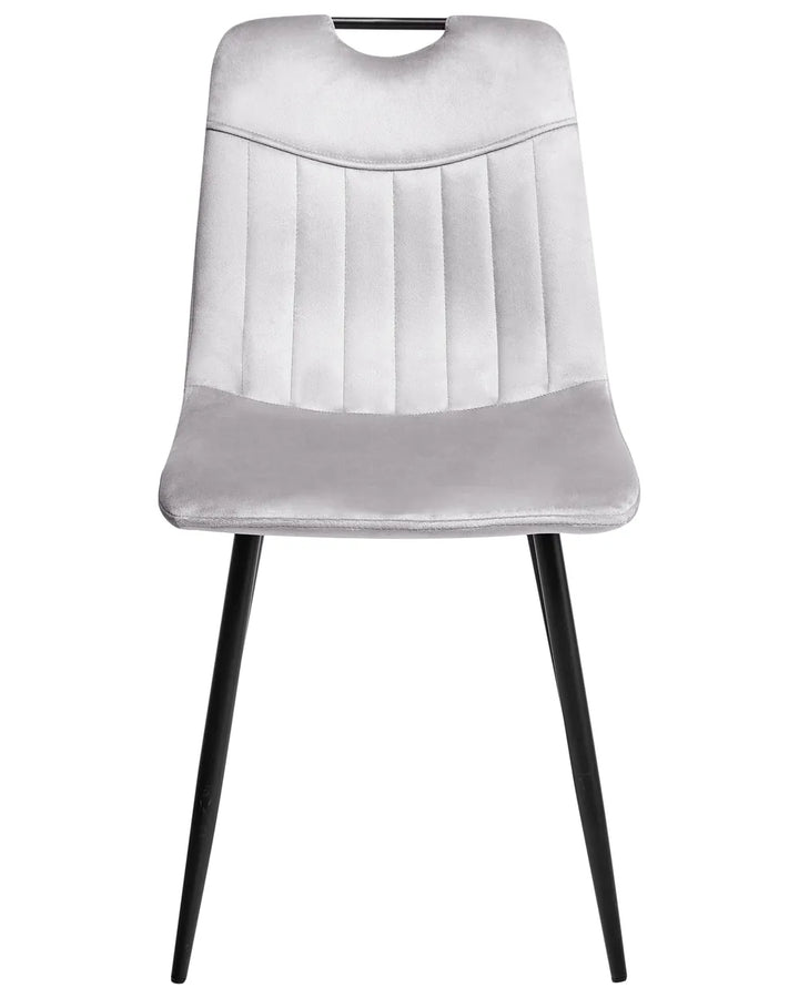Light grey velvet dining chair with a tufted upholstered backrest and padded seat, on slender black metal legs.