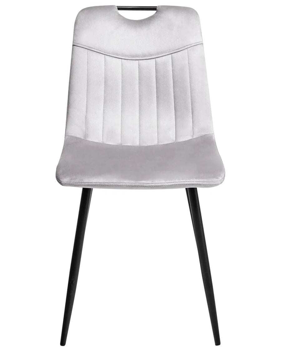 Light grey velvet dining chair with a tufted upholstered backrest and padded seat, on slender black metal legs.