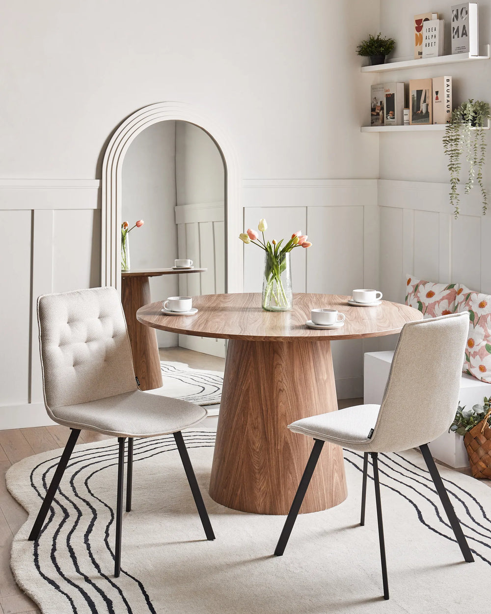 Modern beige dining chairs paired with a round wood table, creating a bright and inviting dining area.