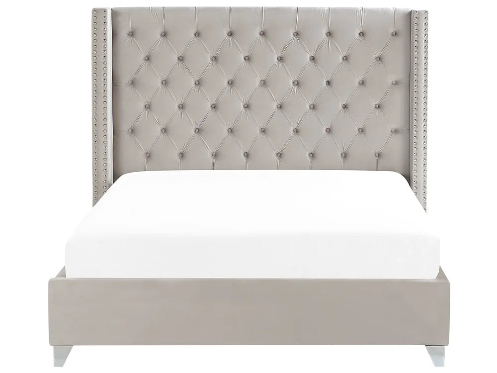 Gray upholstered bed with tufted headboard on a white background