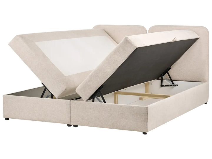 Beige upholstered bed with storage compartments on a white background