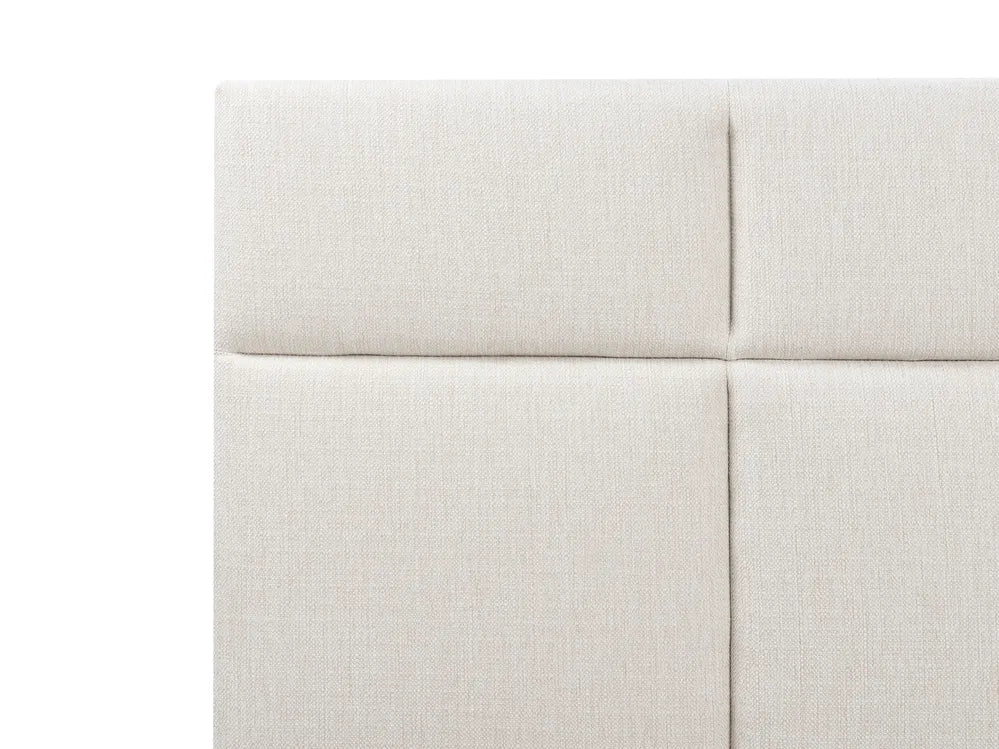 Close-up of a light gray upholstered headboard with a white background