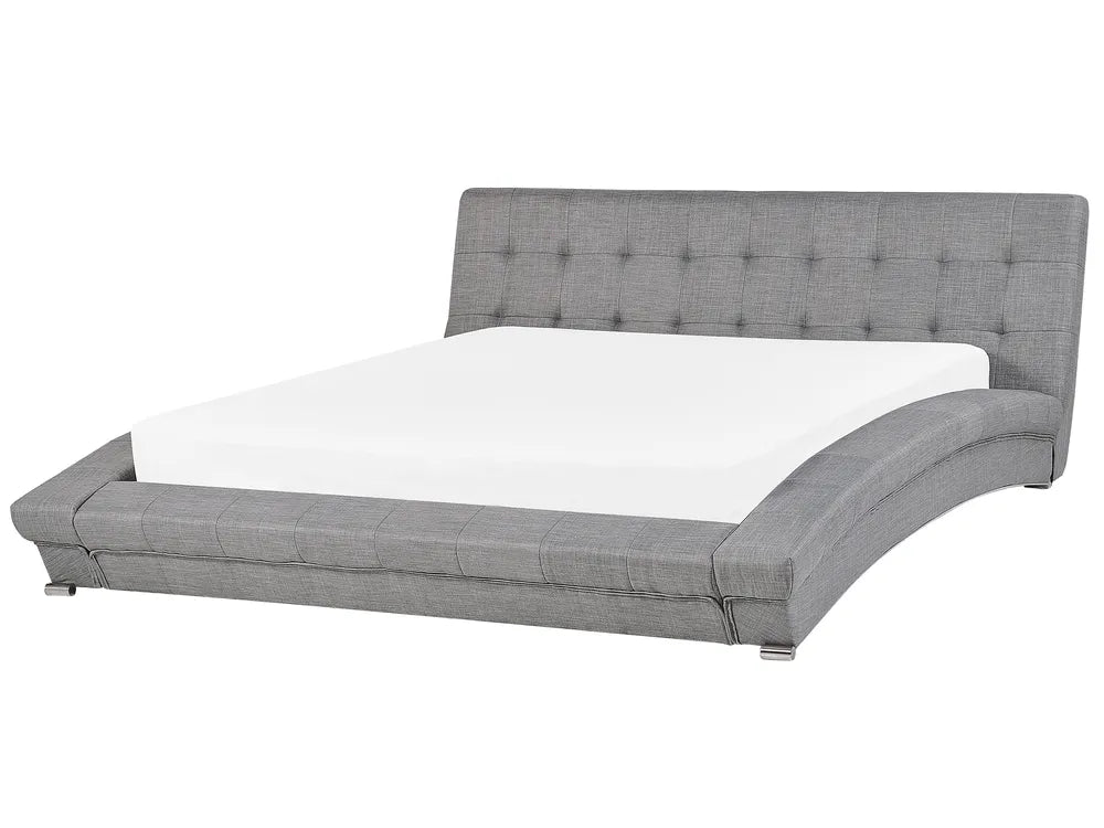 Gray upholstered bed with tufted headboard on a white background