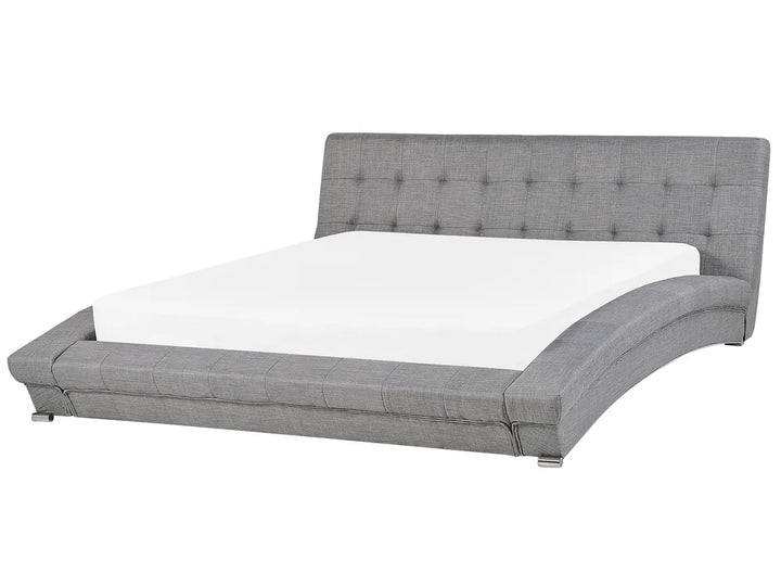 Gray upholstered bed with tufted headboard on a white background