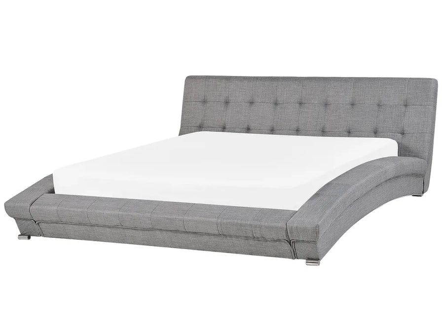 Gray upholstered bed with tufted headboard on a white background