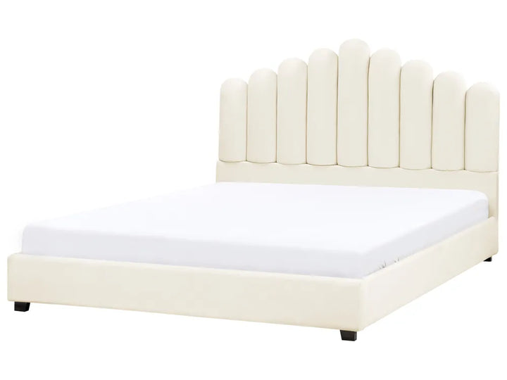 Beige upholstered bed with a white mattress on a white background