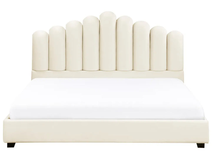 Beige upholstered bed with a white mattress on a white background