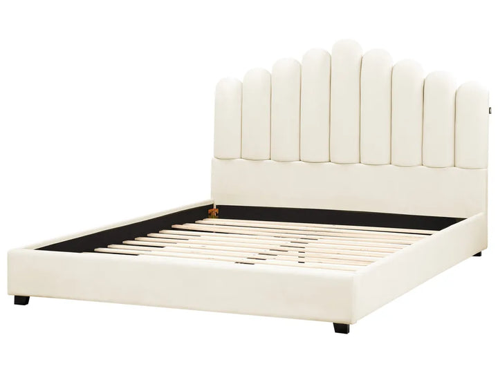 White upholstered bed with a tufted headboard on a white background
