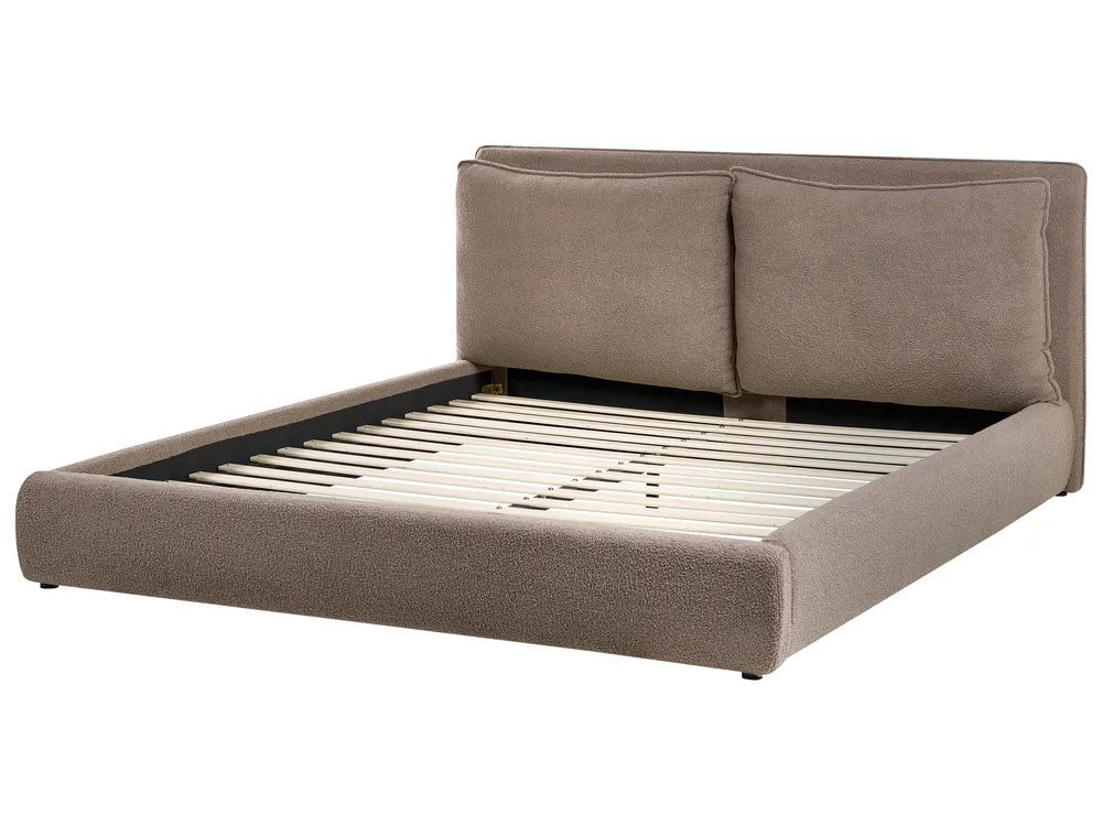 Beige upholstered bed frame on a white background