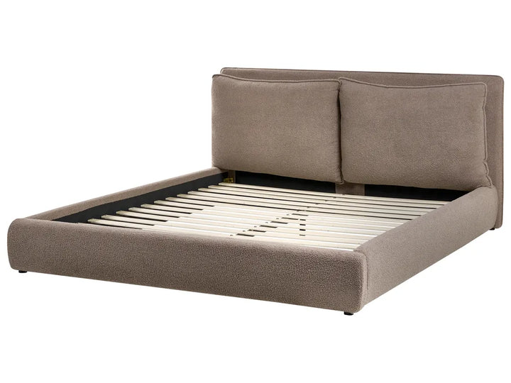 Beige upholstered bed frame on a white background
