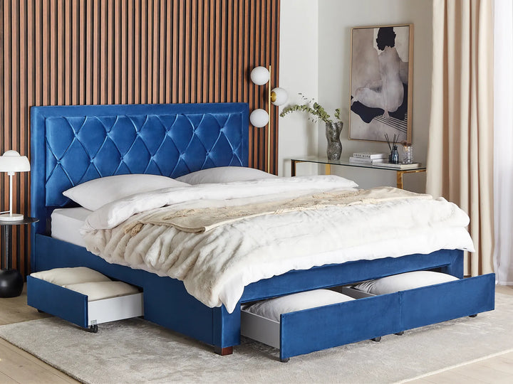 Blue upholstered bed with storage drawers in a bedroom setting