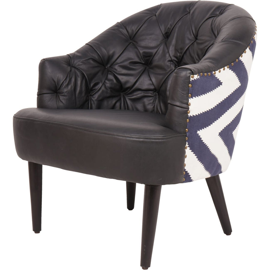 Black leather armchair with a patterned throw blanket on a white background