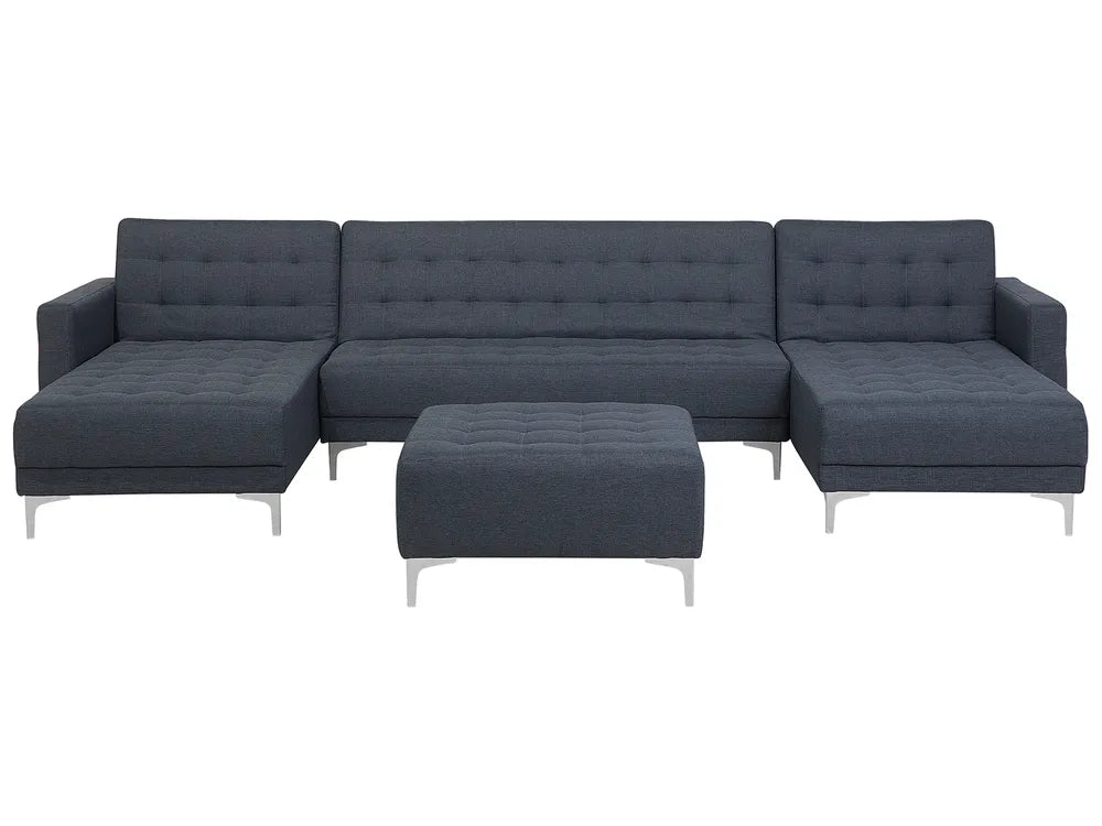 Dark grey fabric U‑shaped 5‑seater modular sofa with ottoman in a contemporary living room