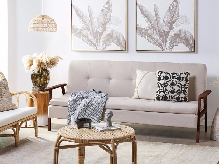 Living room with a beige sofa, wooden coffee table, and decorative elements.