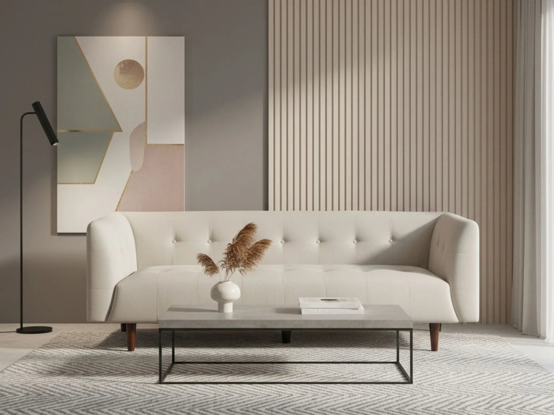 Modern living room with a white sofa, abstract painting, and decorative elements.