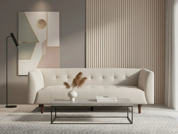 Modern living room with a white sofa, abstract painting, and decorative elements.